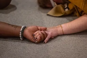 Velvet Rage, Act 2 — two hands clasped on the gallery floor